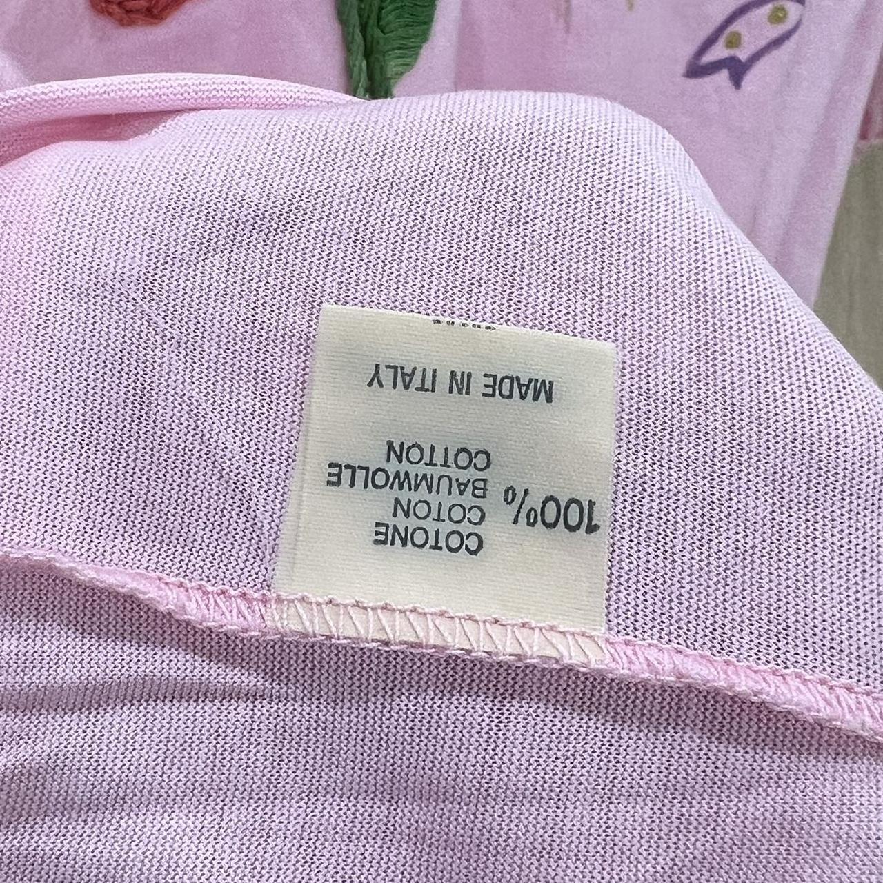 Label on a pink fabric item indicating 'Made in Italy' and '100% Cotton'