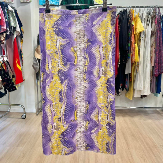 Purple and yellow patterned skirt hanging on a rack in a clothing store