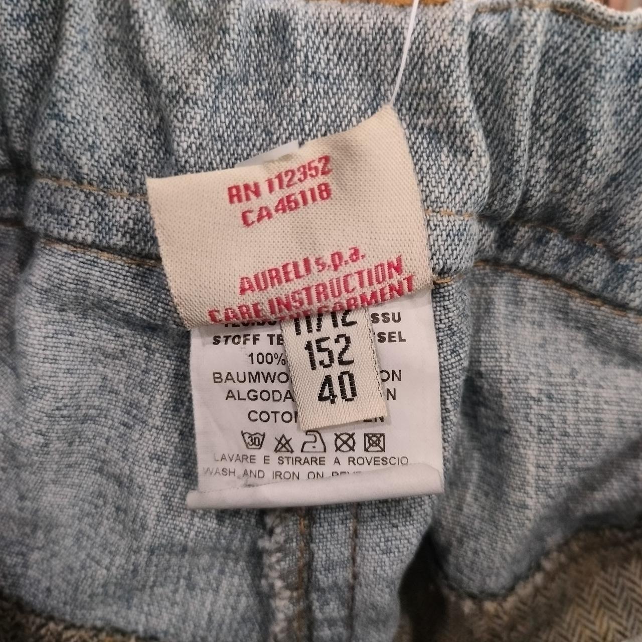 Close-up of a clothing tag on a textured fabric background