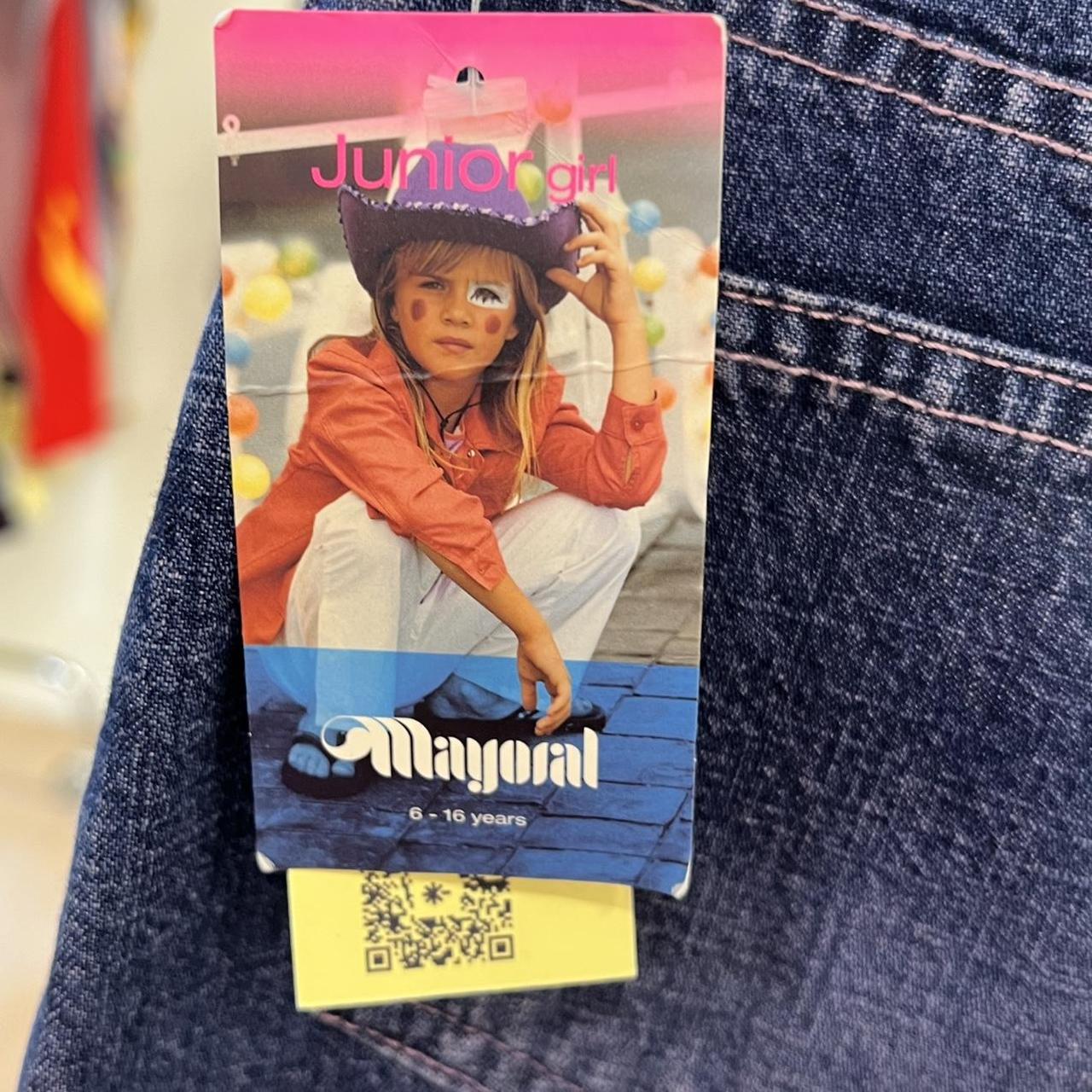 Mayoral junior girl clothing tag on a denim background