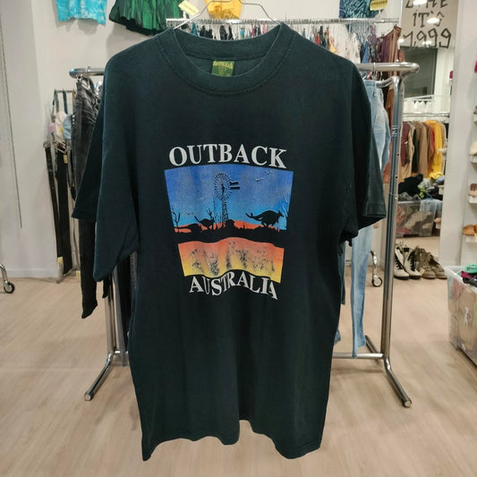 Black t-shirt with 'Outback Australia' graphic in a store setting