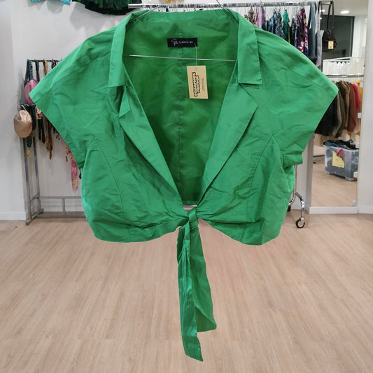 Green shirt with a tag on a wooden floor in a store setting