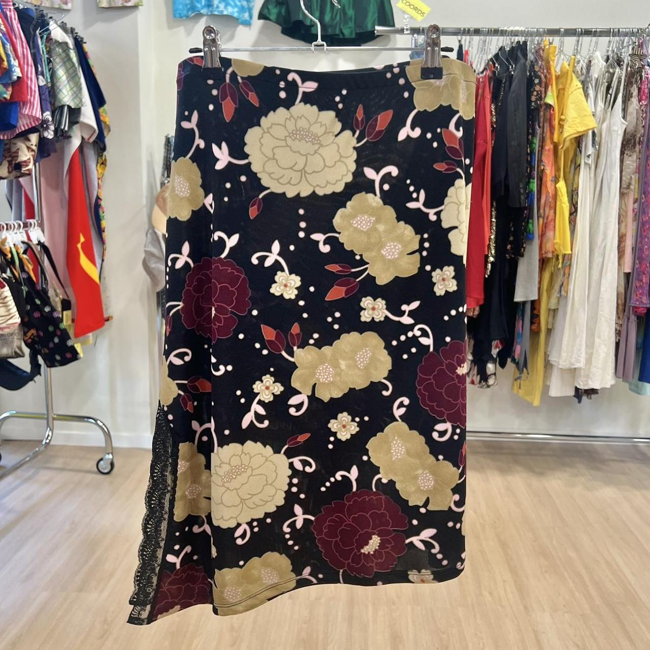 Floral-patterned dress hanging on a rack in a clothing store