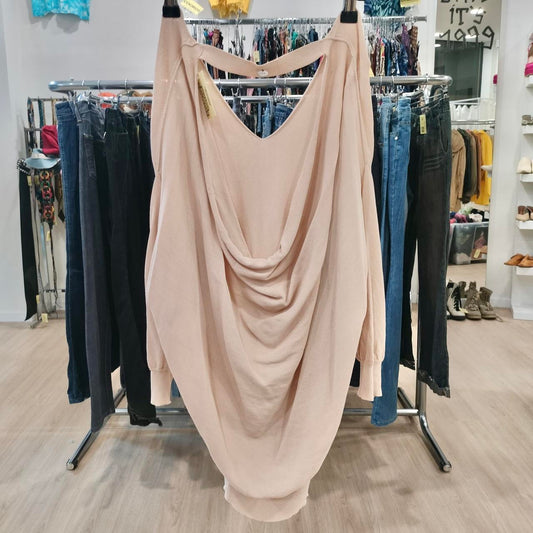 Beige draped top on a rack in a clothing store