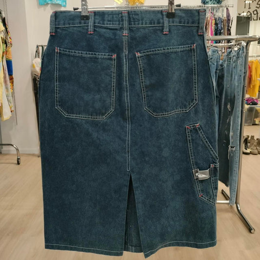 Blue denim skirt on a hanger in a store setting