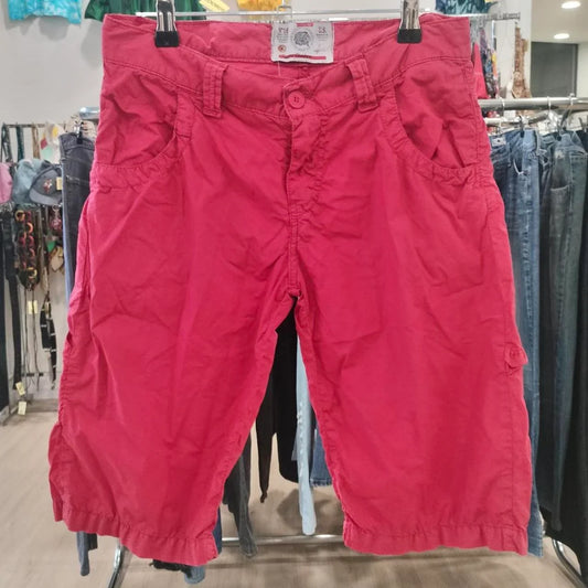 Red knee-length cargo shorts on hanger in second hand clothing store