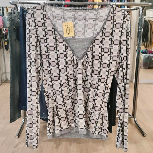 Geometric pattern long sleeve second hand blouse on rack in sustainable fashion store