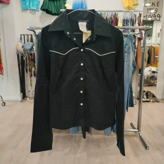 Black jacket with white trim on a rack in a clothing store