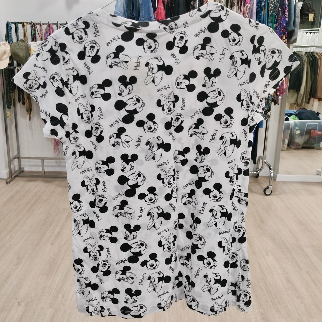 White t-shirt with black Mickey and Minnie Mouse print, displayed in second hand clothing store