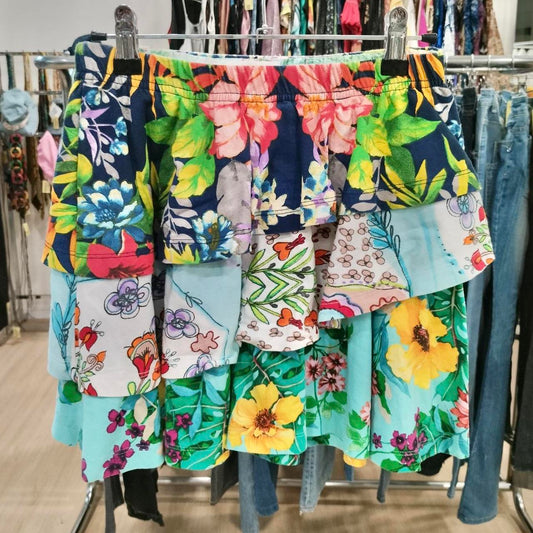 Colorful floral skirt hanging on a rack in a store setting