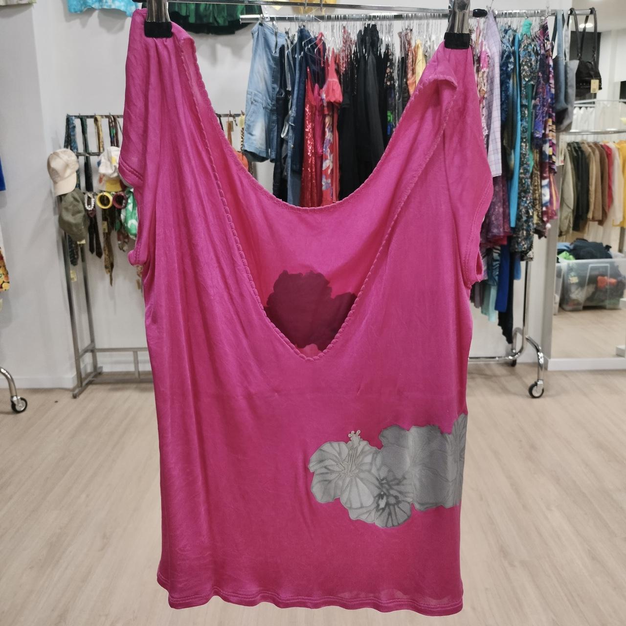Pink dress with floral design on a rack in a store