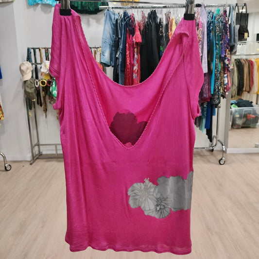 Pink dress with floral design on a rack in a store