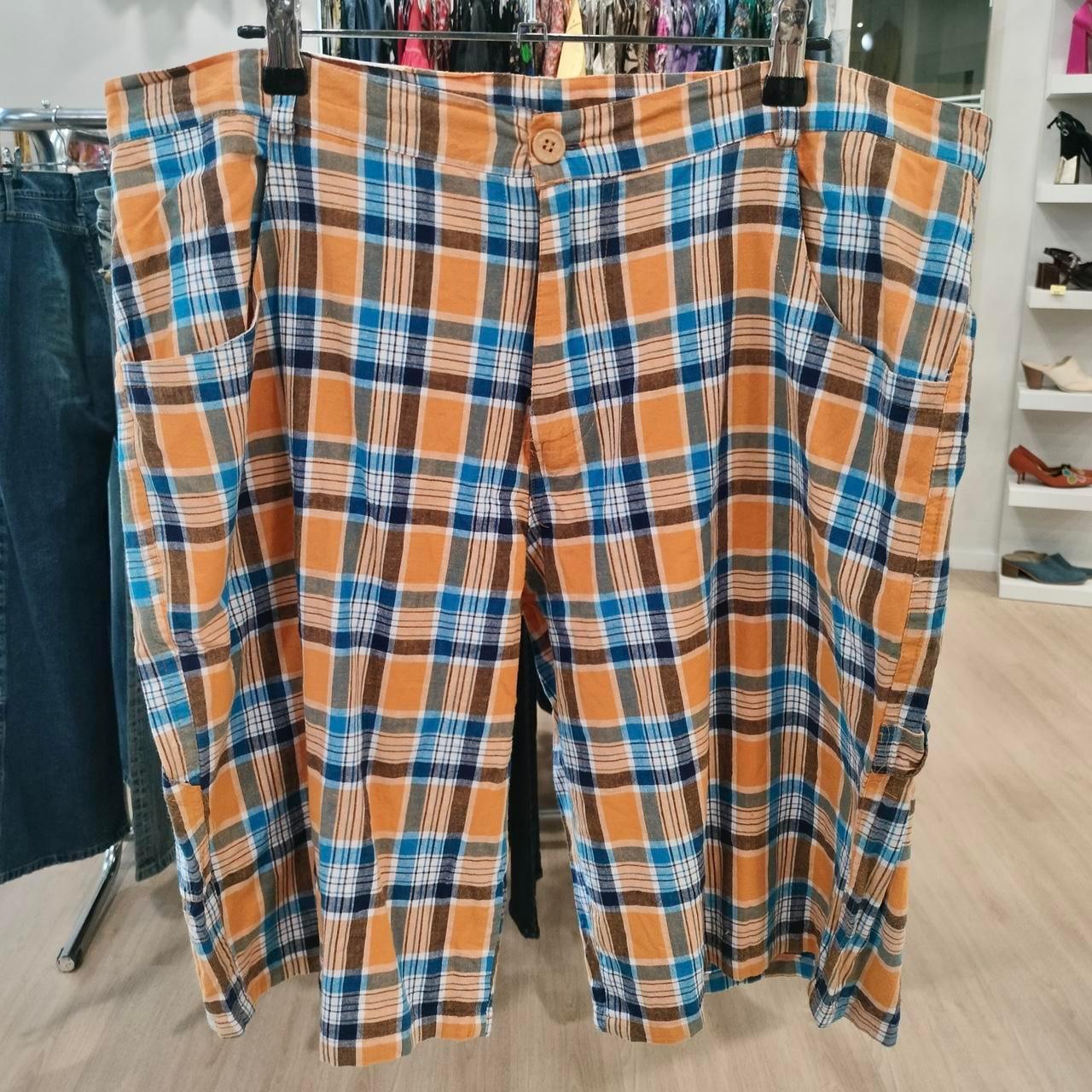 Orange blue plaid cotton shorts with pockets, displayed in a second hand fashion store