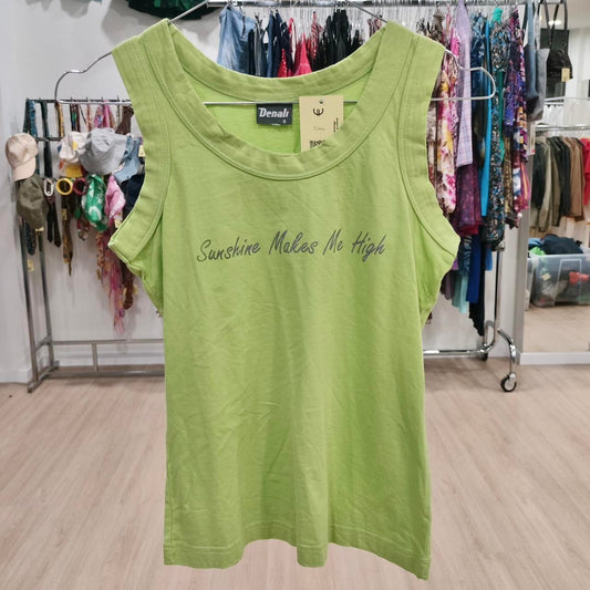Green sleeveless top with 'Sunshine Makes Me High' text, displayed in secondhand clothing store