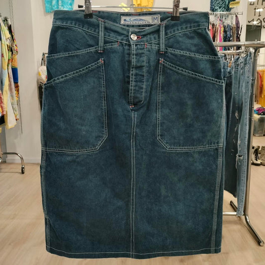 Blue denim skirt on a hanger in a store setting