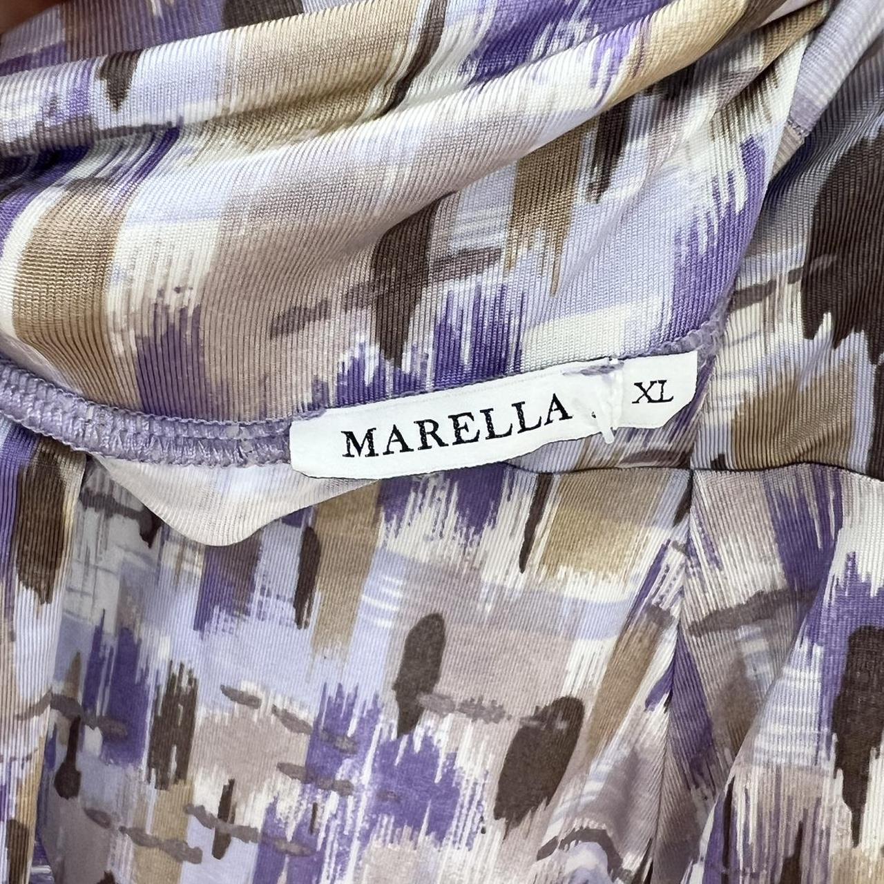 Close-up of a patterned fabric with a Marella label on a multicolored background