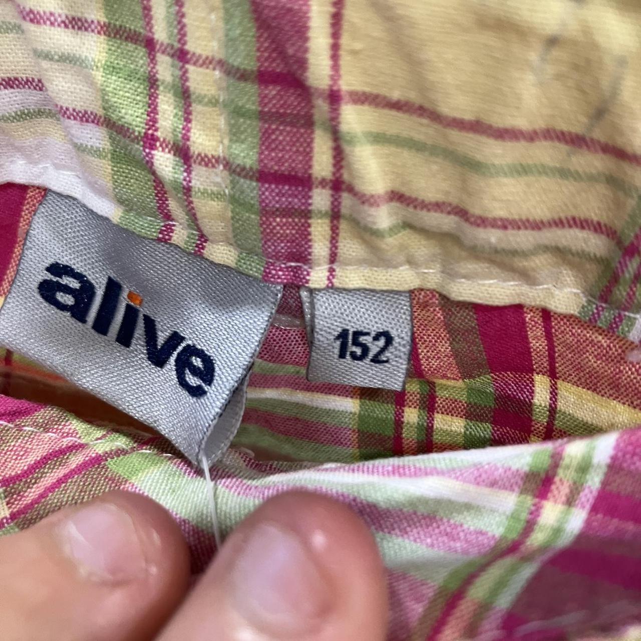 Plaid shirt in pink, yellow, and green with 'alive' brand label and size tag 152