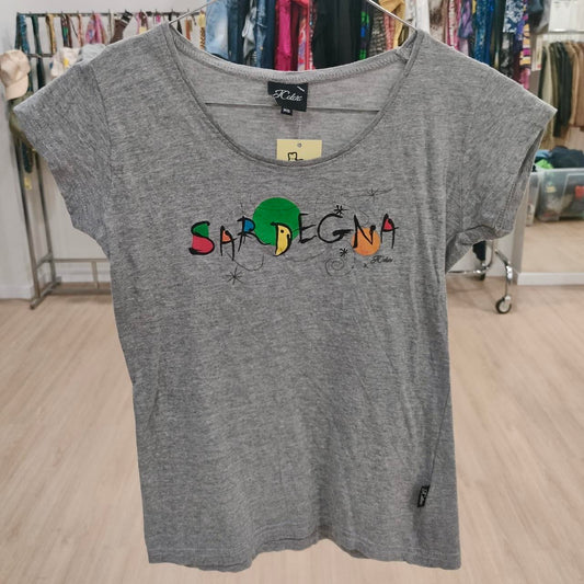 Gray short sleeve t-shirt with colorful 'Sardegna' graphic, displayed in a clothing shop