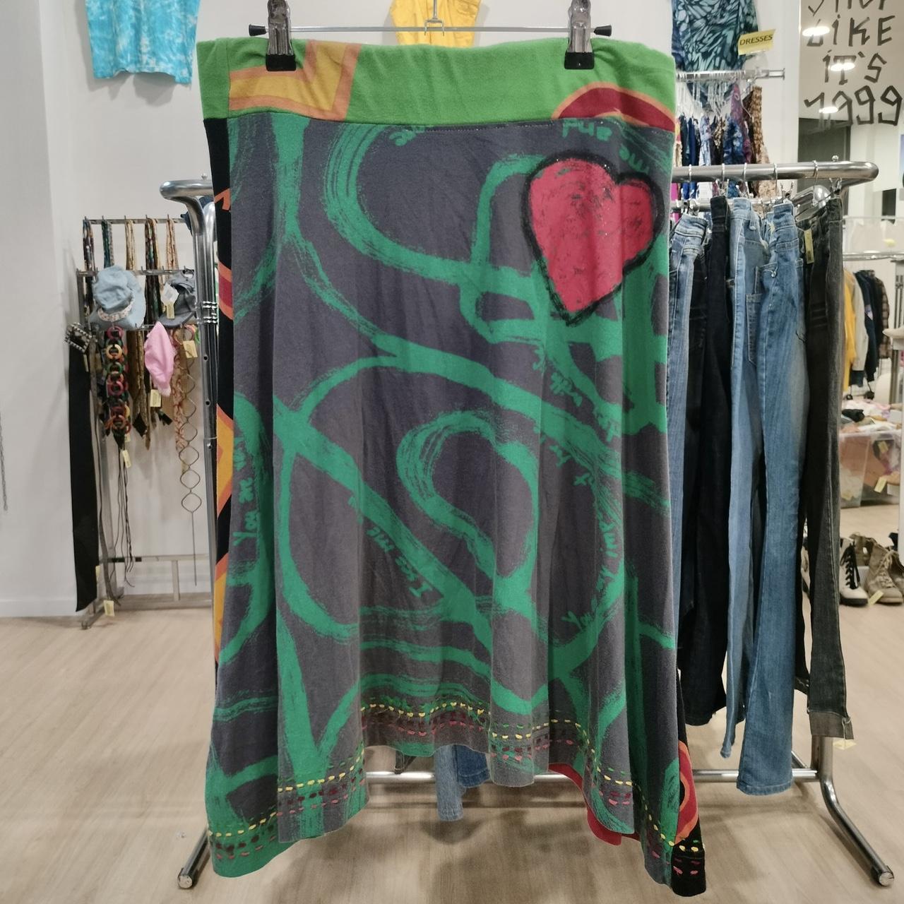 Colorful patterned skirt hanging on a rack in a store setting