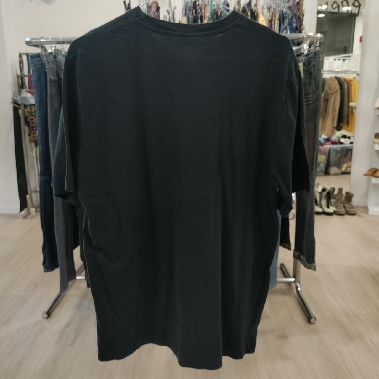 Black t-shirt on a hanger in a clothing store