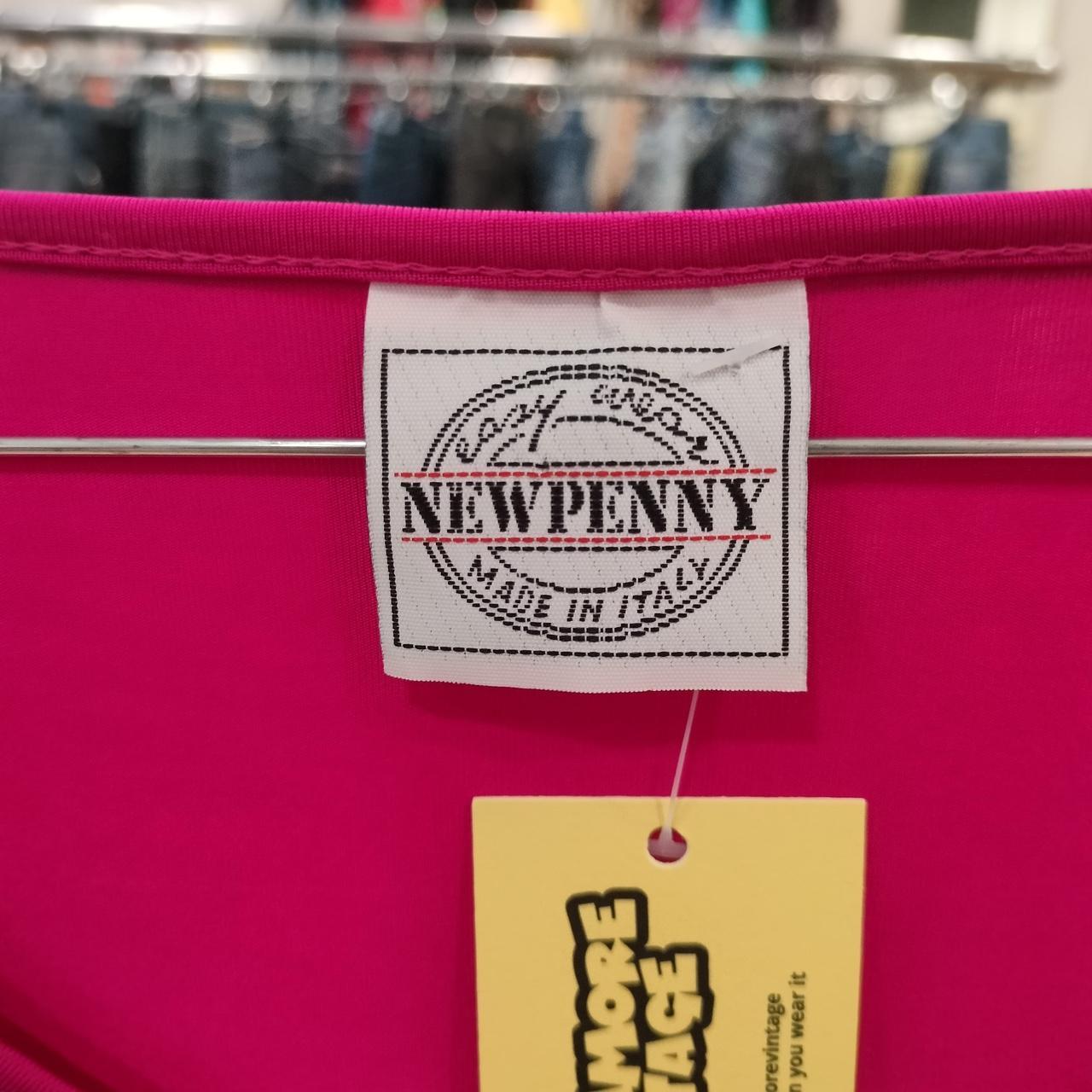 Pink garment with NewPenny label and 'Made in Italy' tag in a store setting