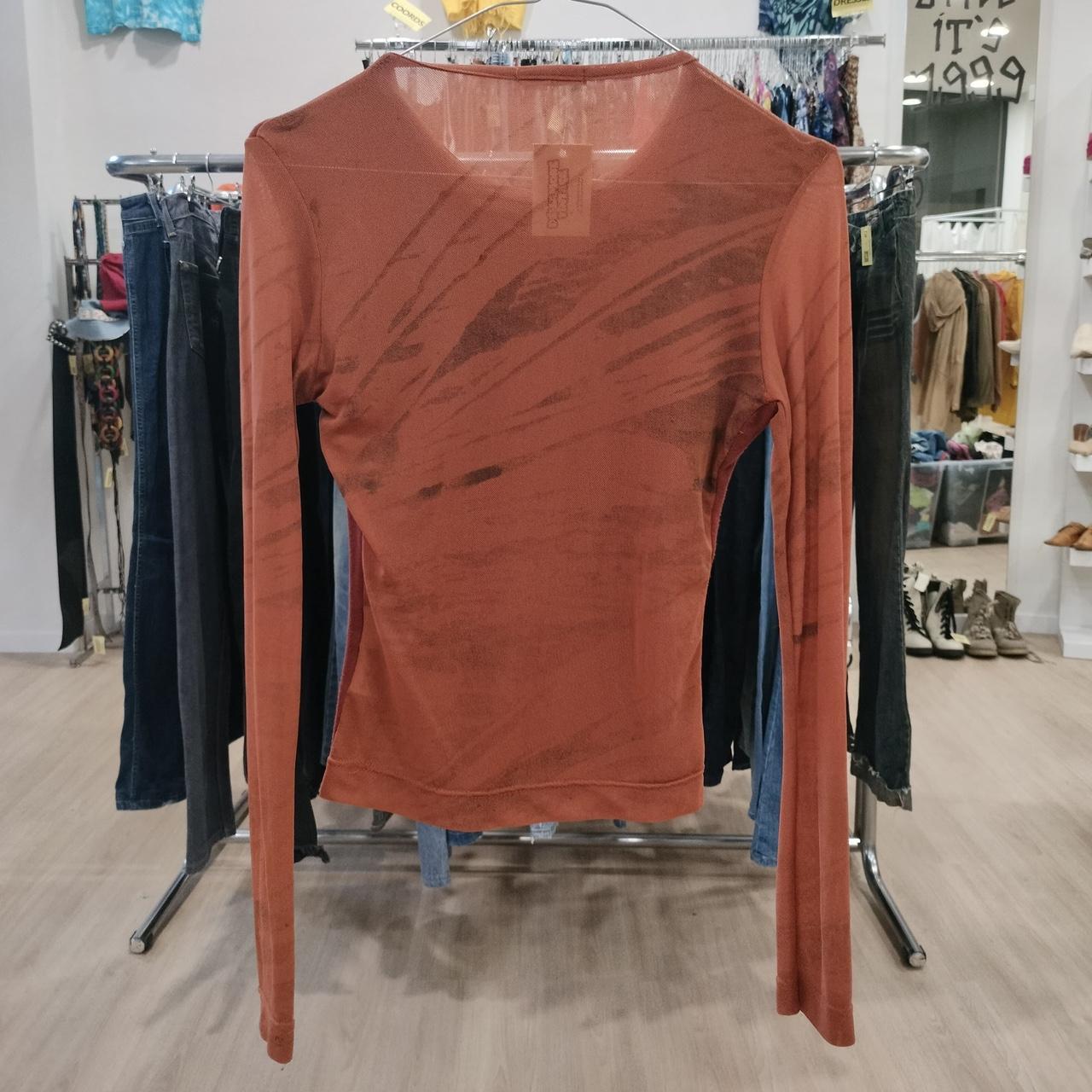Brown long-sleeve shirt on a rack in a clothing store