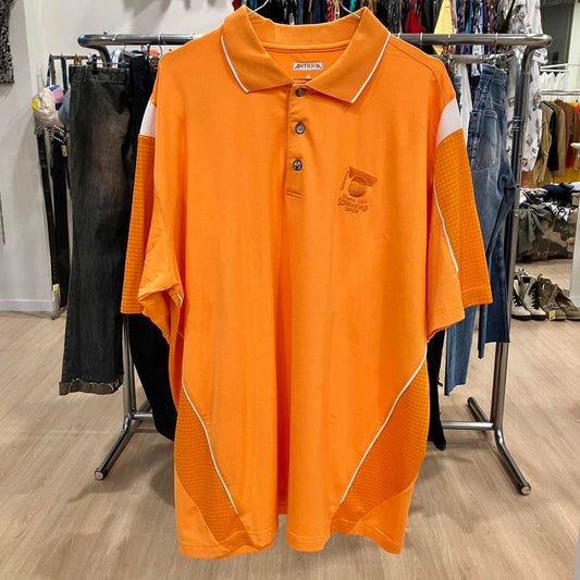 Orange polo shirt with white accents on a rack in a store setting