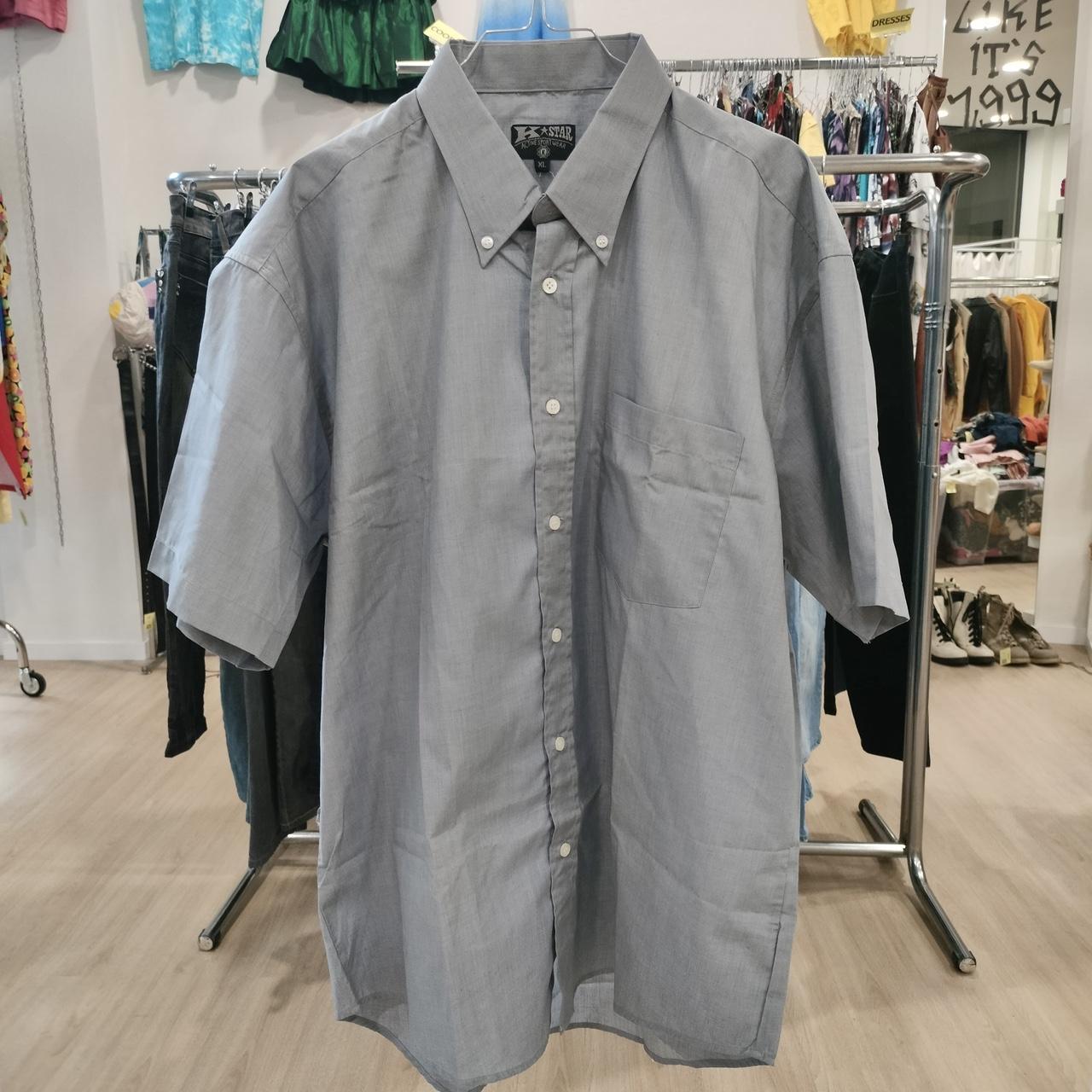 Gray short-sleeve shirt on a rack in a store setting