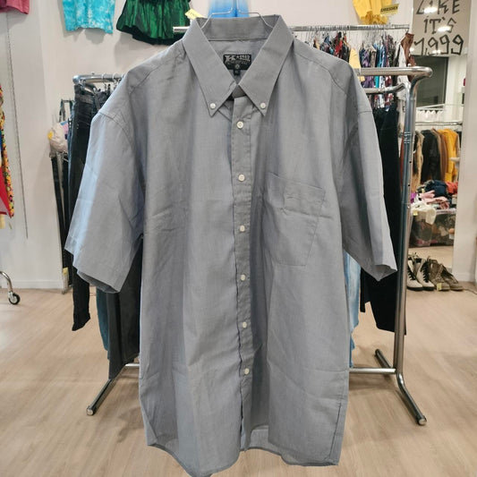 Gray short-sleeve shirt on a rack in a store setting