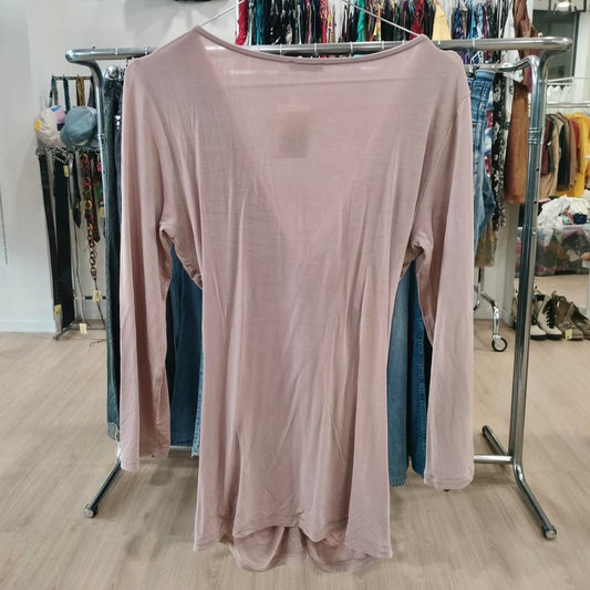 Pink long-sleeve shirt on a rack with a clothing store background