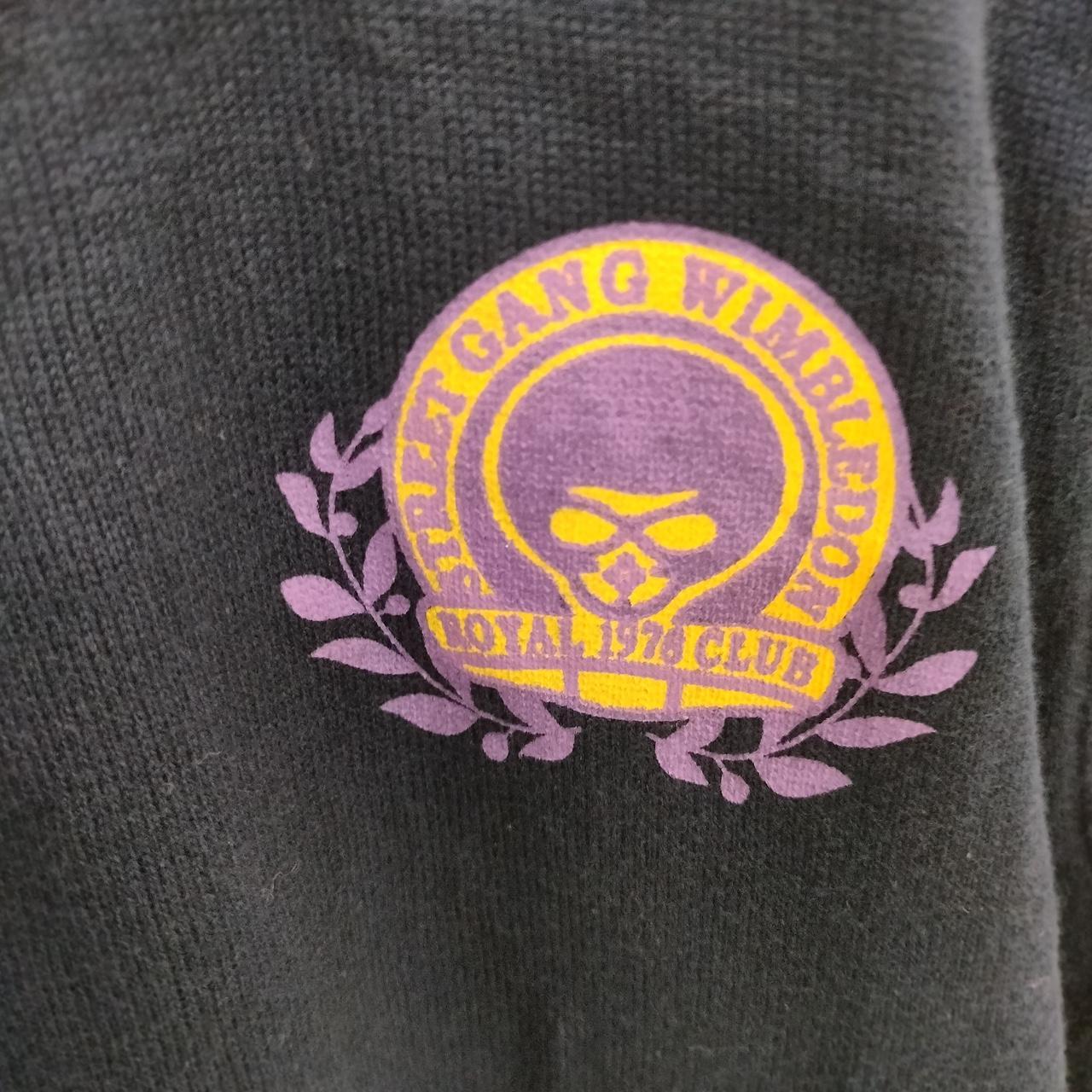 Black knit fabric with purple and yellow skull graphic and 'WIMBLEDON ROYAL 412 CLUB' text