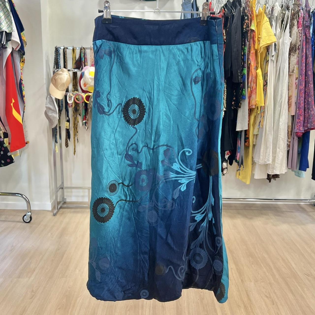 Blue floral-patterned skirt hanging on a rack in a store