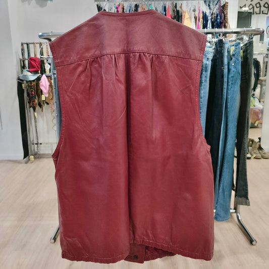 Maroon leather vest on a rack in a store setting