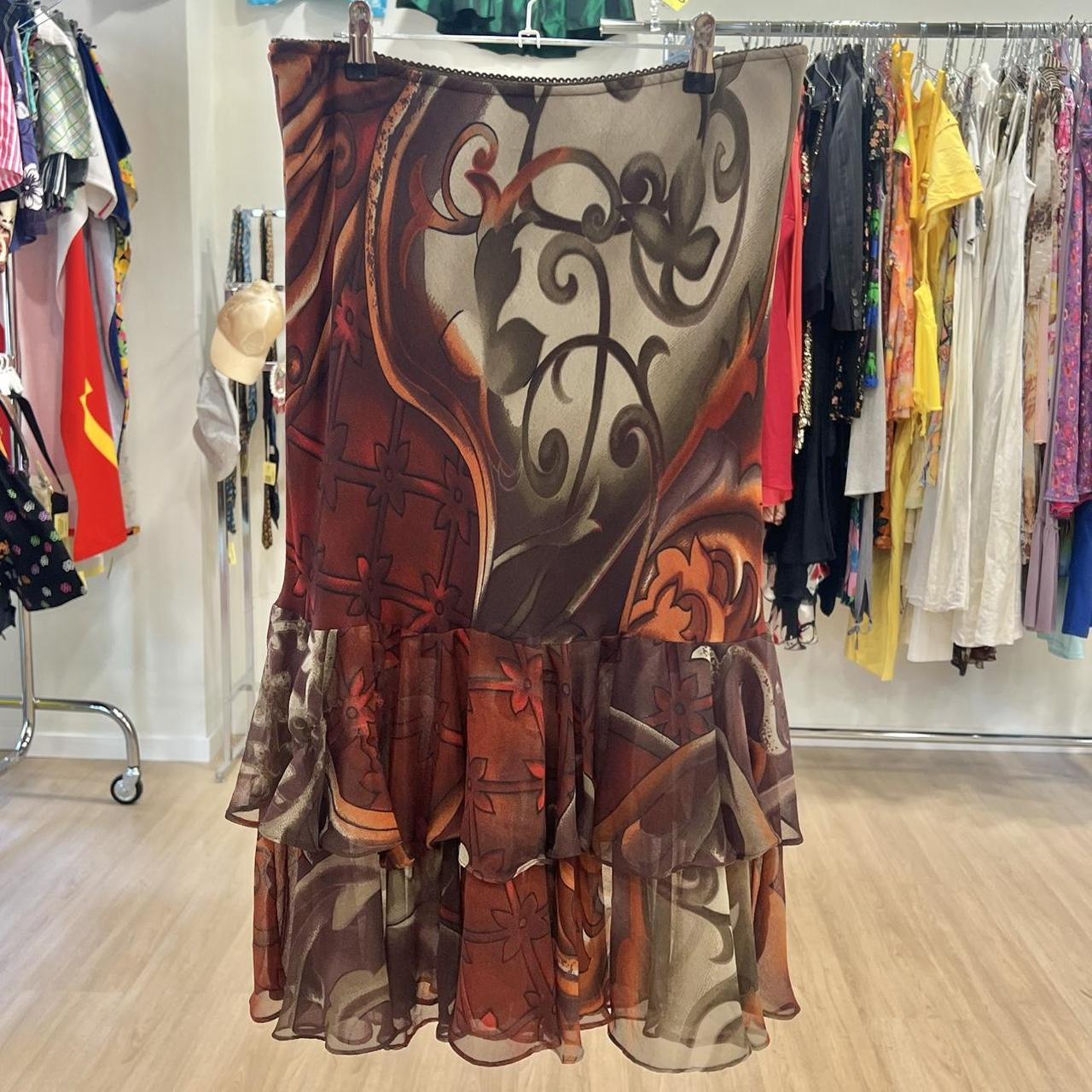 Decorative skirt with intricate patterns hanging on a rack in a store setting