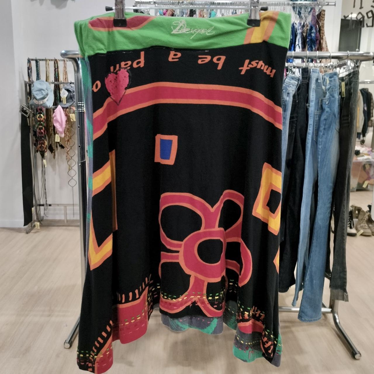 Colorful dress with abstract patterns hanging on a rack in a store
