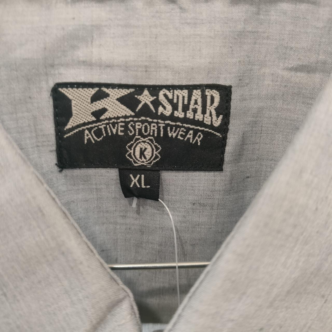 Close-up of a 'K-Star active sportswear' label on gray fabric