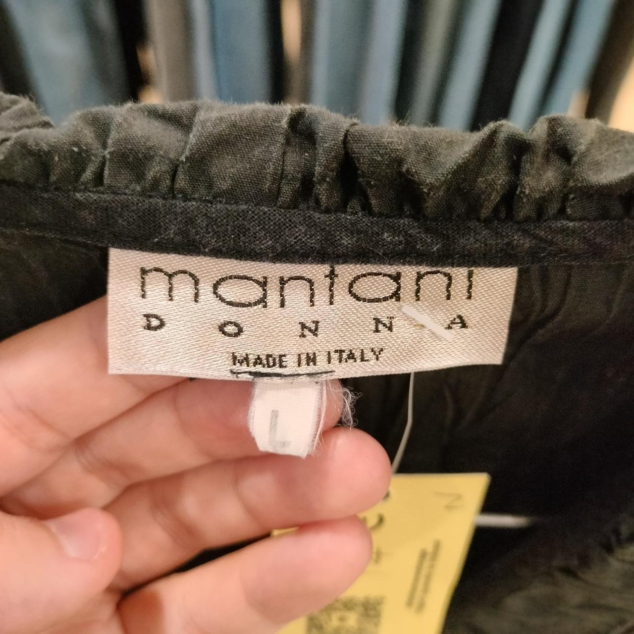 Mantani black ruffle shirt with a touch of whimsy