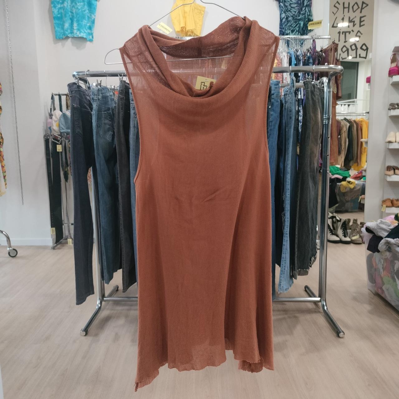 Sleeveless brown mesh tunic dress on hanger in second hand fashion store