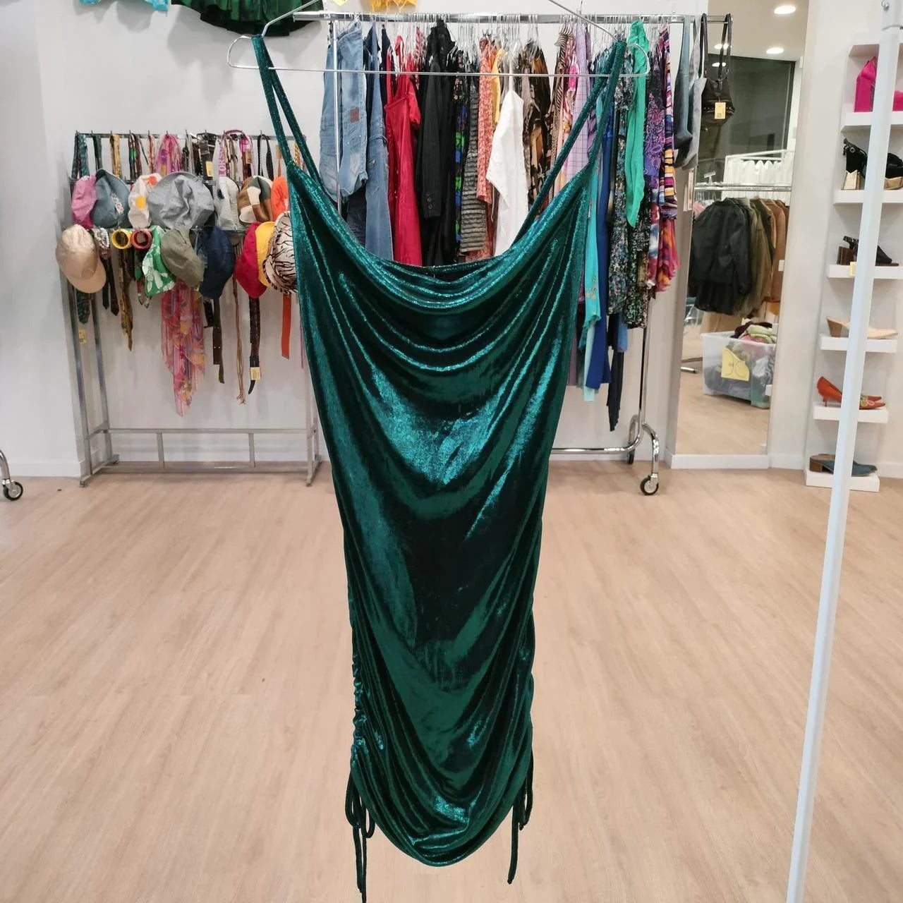Emerald green velvet slip dress with draped neckline in a second hand fashion boutique