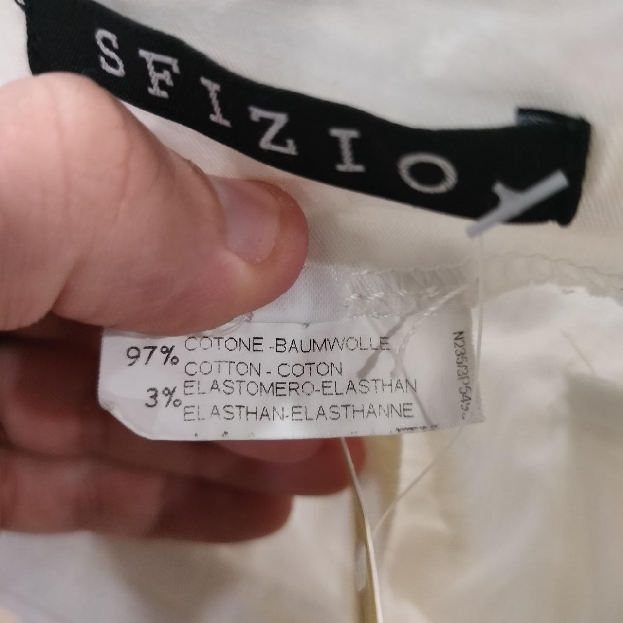 Close-up of fabric care label showing 97% cotton and 3% elastane garment composition