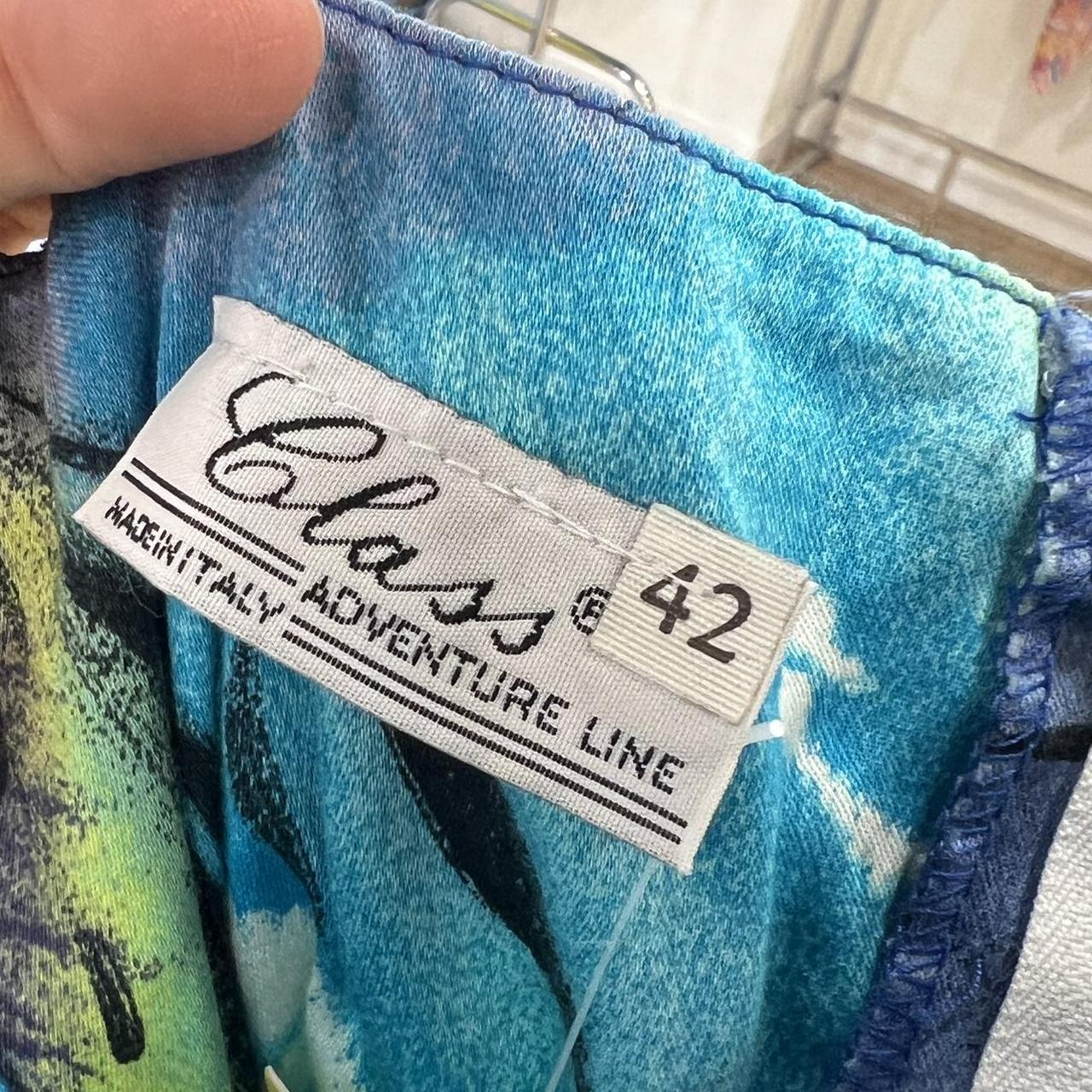 Close-up of a clothing label on a colorful fabric background