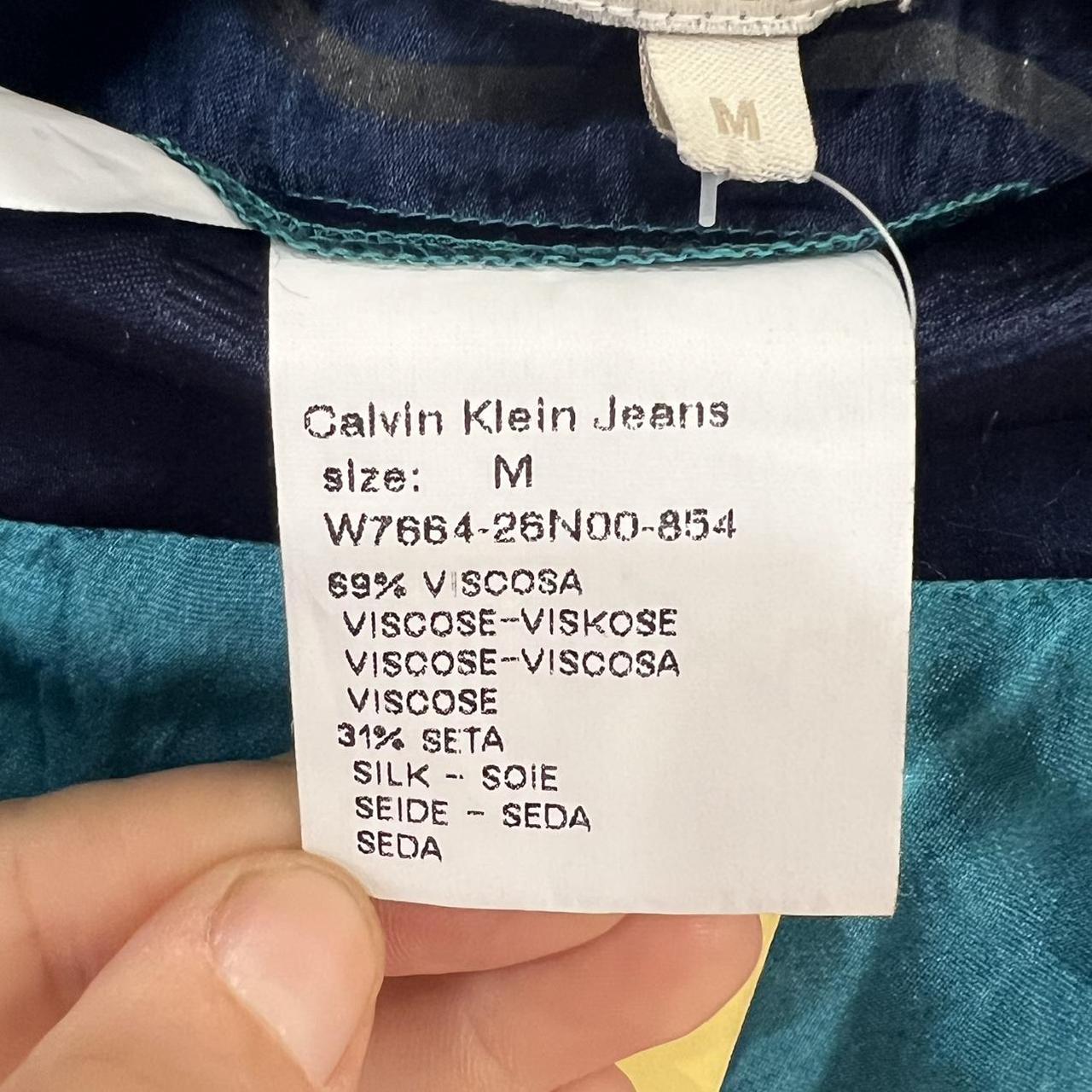 Calvin Klein Jeans label on a garment with fabric background
