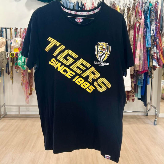 Black t-shirt with yellow text and logo on a rack in a store