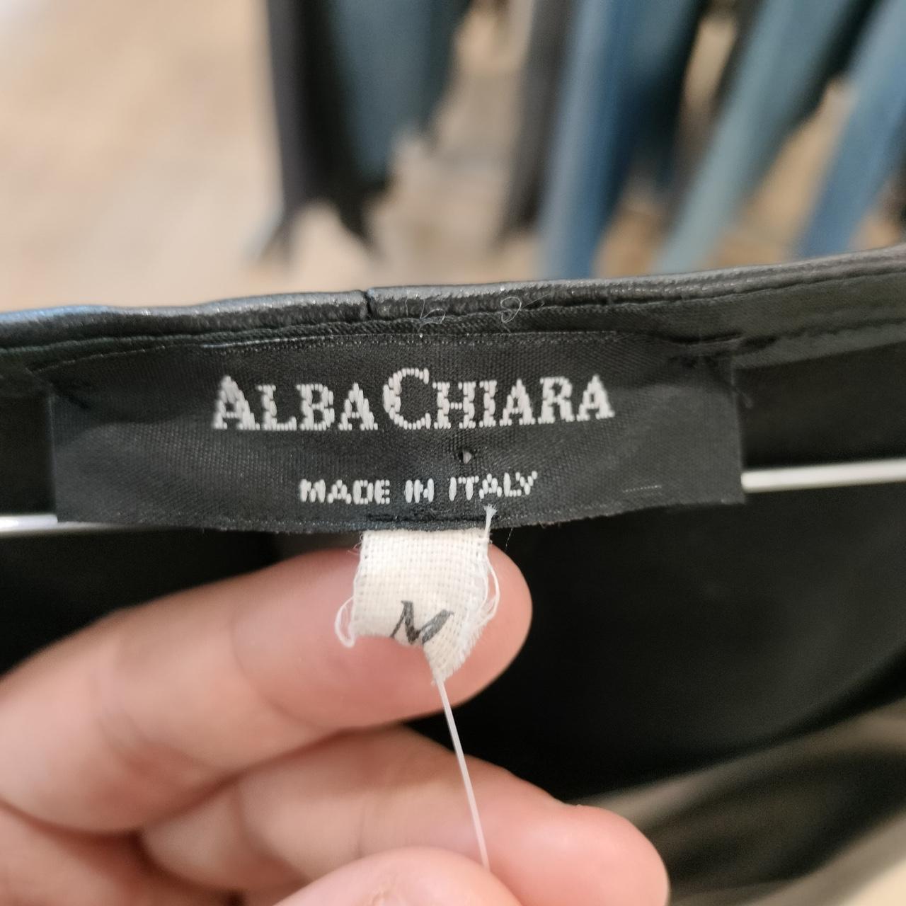 Close-up of a label with 'Alba Chiara' and 'Made in Italy' text on a blurred background