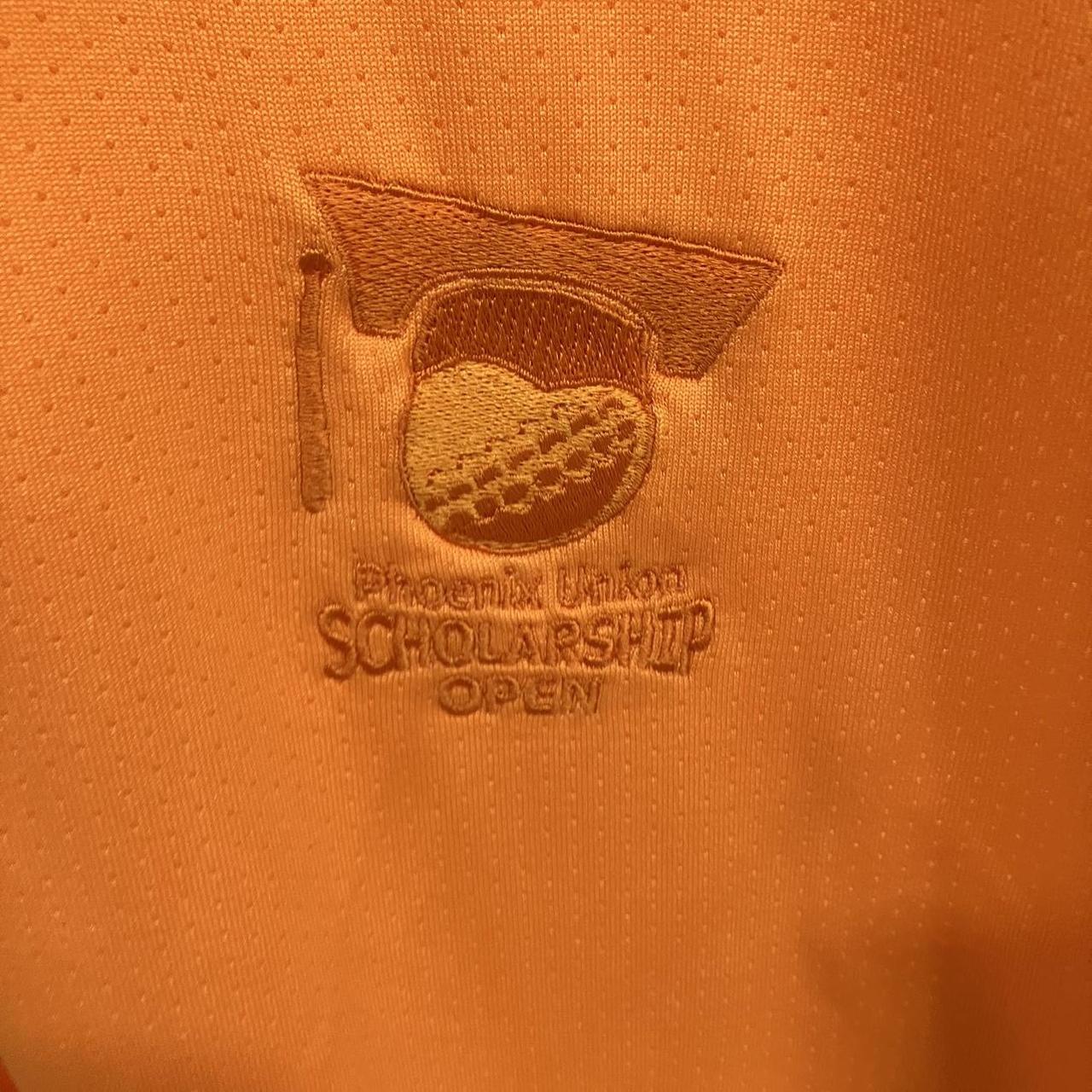 Embroidered logo on an orange fabric with text 'Phoenix Union Scholarship Open'