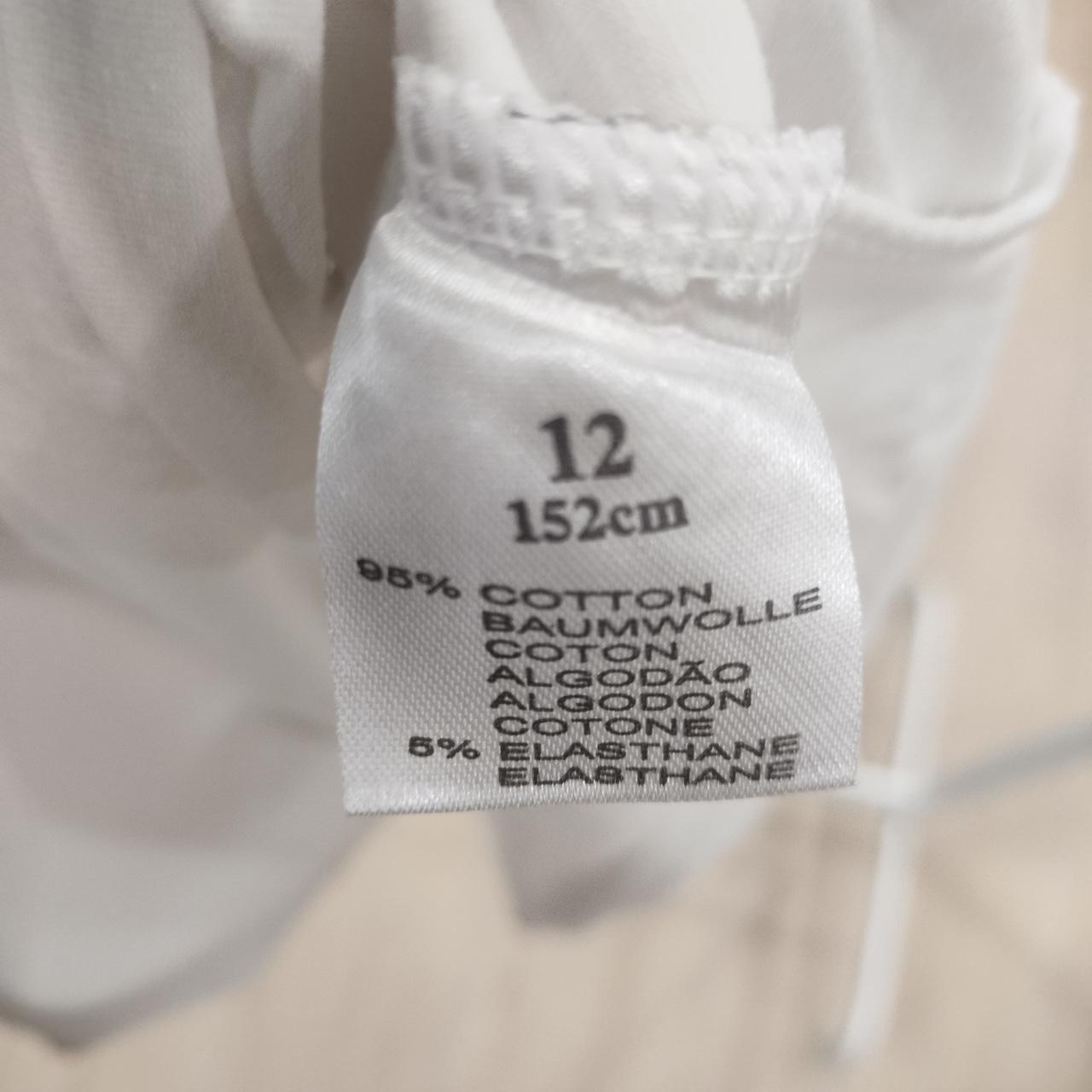 White clothing label showing size 12, 152cm, 95% cotton, 5% elastane